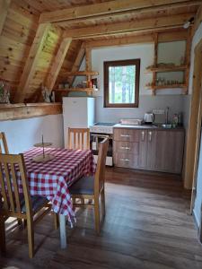 a kitchen and dining room with a table and chairs at Vikendica Smolovic in Žabljak +11 photos