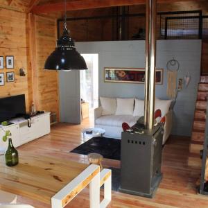 a living room with a wood burning stove in it at Cabaña sobre el Lago Cholila in Cholila