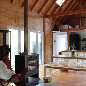 a kitchen with a stove and a table in a room at Cabaña sobre el Lago Cholila in Cholila +13 photos