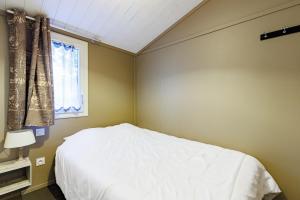a bedroom with a white bed and a window at Azur de La Cigale -Conciergerieland in Azur +16 photos