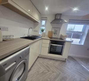 a kitchen with a sink and a dishwasher at The Loft Studio Westbury in Westbury