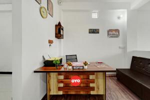 a living room with a table and a couch at Hotel O Radha Krishna Family Hotel in Naubatpur