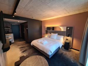 a bedroom with a large bed with two towels on it at Mercure Hotel Delémont in Delémont