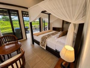 a bedroom with a bed with a canopy at The Kubu Sidemen 2 in Silebeng