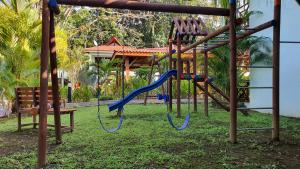 a playground with a slide in a park at Bungalows Beachfront Hotel in Punta Uva +37 photos