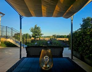 a table under a canopy on a patio at Chicche di Lavanda in Valmadonna