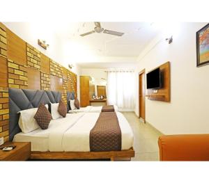 a bedroom with a large bed and a television at Royal with - Group Name Hotel Double R- comfort stay in Main Bazar New Delhi in New Delhi