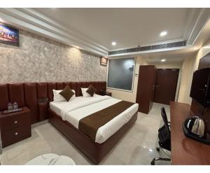 a bedroom with a bed and a flat screen tv at Royal with - Group Name Hotel Double R- comfort stay in Main Bazar New Delhi in New Delhi