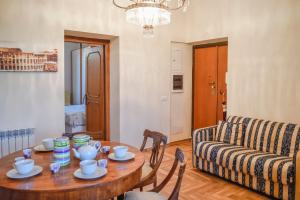 a living room with a table and a couch at Penthouse Angelo Brunetti in Rome +19 photos