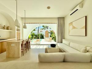 a living room with a couch and a table at Dolce Suites in Uluwatu