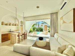 a living room with a white couch and a table at Dolce Suites in Uluwatu