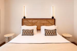 a bedroom with a large bed with two pillows at Crisol Belle Epoque in Cannes