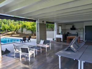 a living room with chairs and a swimming pool at Borgo Ragnitill in Lanciano