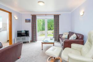 a living room with a couch and a tv at Heddfan Cottage in Haverfordwest