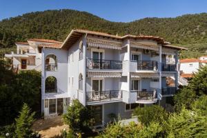 a large apartment building with balconies on a hill at Doma by Kristina in Chrysi Ammoudia