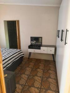 a bedroom with a bed and a dresser with a mirror at Root&Roam Nature in Malelane