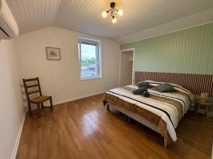 a bedroom with a large bed and a window at La Maison du Bief in Écuisses