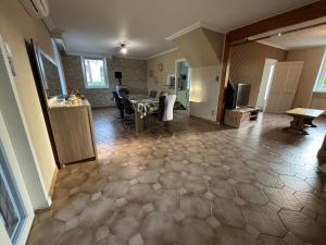 a living room with a table and a dining room at La Maison du Bief in Écuisses