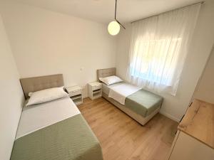 a bedroom with two beds and a window at Dalmatinac Residence in Orebić
