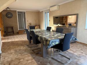 a dining room with a table and chairs at La Maison du Bief in Écuisses +11 photos