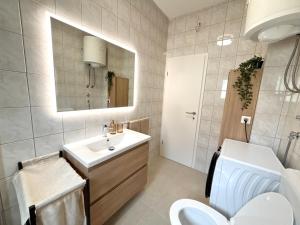 a bathroom with a sink and a toilet and a mirror at Dalmatinac Residence in Orebić +34 photos