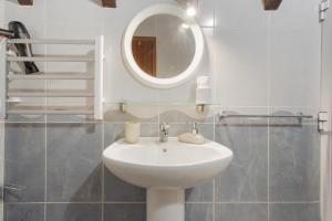 a bathroom with a white sink and a mirror at Sunset Village in São Jorge +36 photos