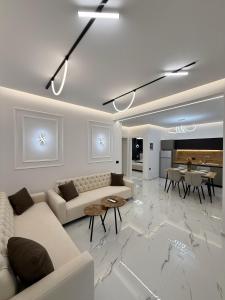 a living room with a couch and a table at Apartments Oda Hotel in Velipojë