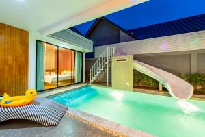 a swimming pool with a slide in a house at King Arthur Pool Villa in Nong Prue