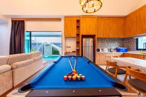 a living room with a pool table at King Arthur Pool Villa in Nong Prue
