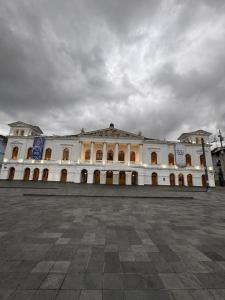 a large white building with a lot of windows at Hostal Marín Central - Quito in Quito