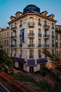 a large white building with a sign on it at Crisol Belle Epoque in Cannes +46 photos