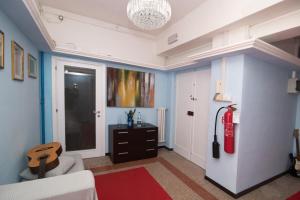 a living room with a guitar on the wall at Maa Guest House in Civitavecchia +58 photos
