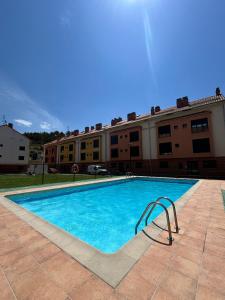 a swimming pool in front of a building at Gran Reserva Cuzcurrita in Cuzcurrita-Río Tirón