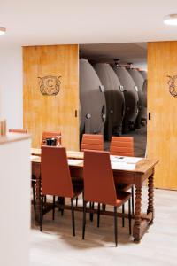 a dining room with a table and chairs and wine barrels at Château Catherine de Montgolfier - B&B et Gites - Piscine - Domaine viticole bio avec dégustation in Narbonne +75 photos
