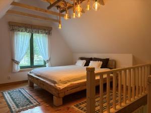 a bedroom with a large bed with blue curtains at Pompei Village in Cojocani