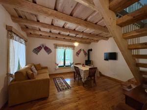 a living room with a couch and a table at Pompei Village in Cojocani