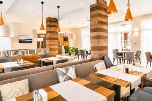 a restaurant with couches and tables and chairs at St. Panteleimon Beach Hotel in Nesebar