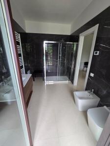 a bathroom with two sinks and a toilet and a shower at b&b la Conocchia in Curti +19 photos