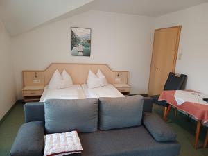 a living room with a couch and a bed at Haus zur Linde in Wagrain