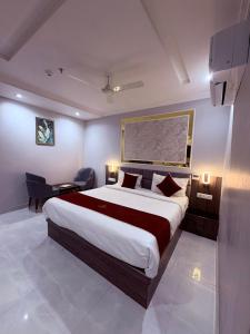 a bedroom with a large bed in a room at The Hotel Sundaram Continental in Prayagraj