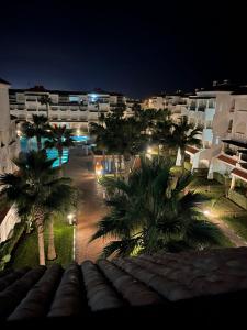 a view of a resort at night with palm trees at Garden Beach 2 in Sidi Rahal
