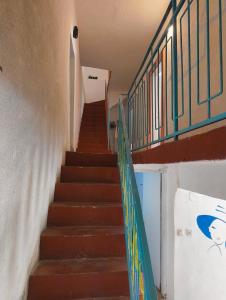 a stairway with a green railing and a stair case at Old Town Casa in Ulcinj