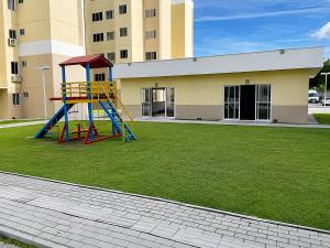 a playground with a slide in front of a building at Hosts BR - Apartamentos funcionais in Fortaleza