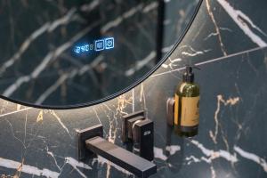 a bottle of wine on a counter in front of a mirror at Gerania nature Residence 22 in Siátista +22 photos