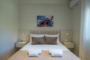 a bedroom with a bed with two pillows on it at Gerania nature Residence 22 in Siátista