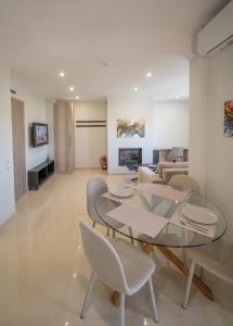 a living room with a glass table and chairs at Gerania nature Residence 22 in Siátista