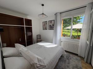 a bedroom with a bed and a window at Le petit gîte in Saint-Étienne-le-Laus