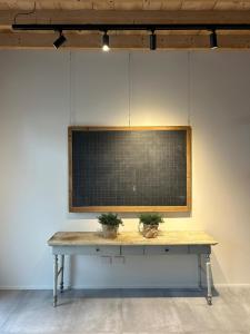 a table in a room with two plants on it at Camere Via Pasubio in Thiene