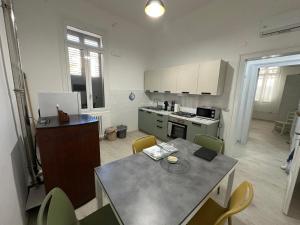 a kitchen with a table and chairs in a room at Casa Pinuccio Sapri in Sapri