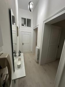 a bathroom with a toilet and a sink and a mirror at Casa Pinuccio Sapri in Sapri +9 photos